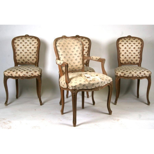 1004 - A set of eight French limed beech dining chairs with upholstered seats and backs, on cabriole front ... 