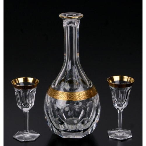 102 - A Moser lead crystal decanter and two glasses with gilt decoration (decanter lacks stopper) (3).