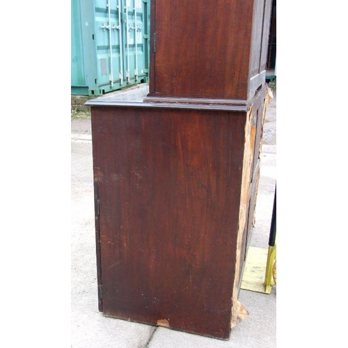 1021 - A 19th century mahogany secretaire cupboard, the dentil cornice above two panelled doors, the lower ... 