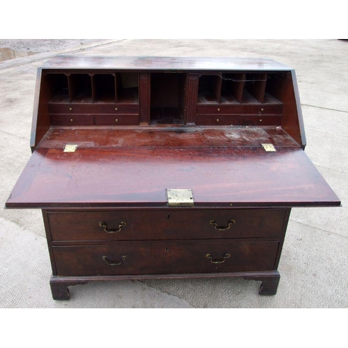 1040 - A Georgian mahogany bureau, the fall-front enclosing a fitted interior above four graduated long dra... 