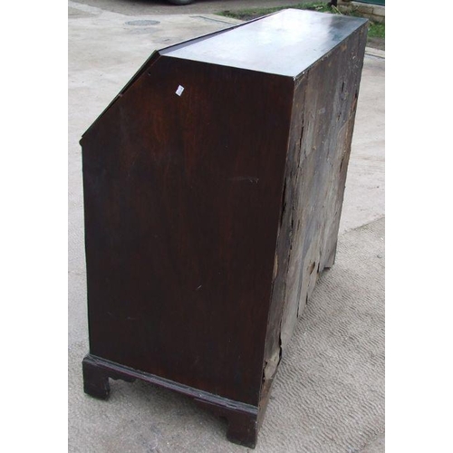 1040 - A Georgian mahogany bureau, the fall-front enclosing a fitted interior above four graduated long dra... 