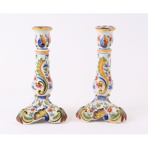 113 - A pair of Quimper faience candlesticks, 23cms high (2).