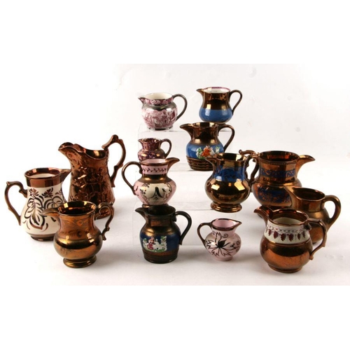 120 - A quantity of late Victorian lustre jugs, the largest 17cms high.