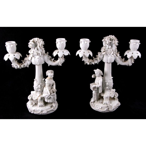 127 - A pair of white glazed continental porcelain candelabra with blue crossed swords mark to the undersi... 