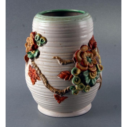 140 - A Clarice Cliff Newport Pottery vase with relief floral decoration, shape no. 899L/S, 20cms high.