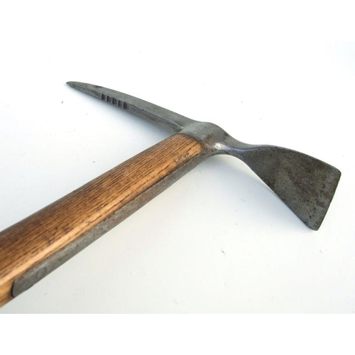 225 - An early 20th century steel mountaineering pickaxe with oak shaft, 90cms long.