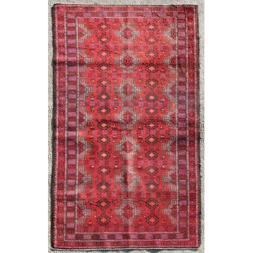 246 - A Persian Balouch woollen rug with stylised guls within multi borders, 205 by 125cms (433).