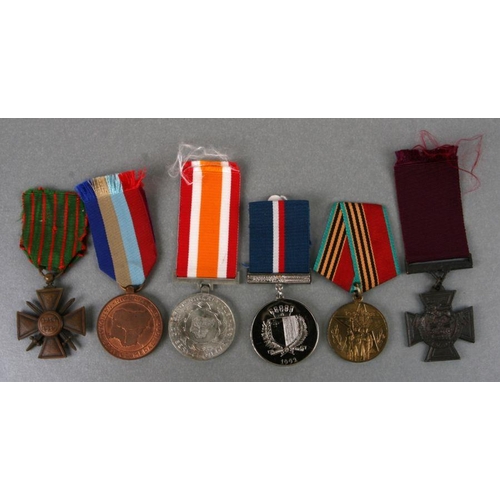 47 - A Malta George Cross commemorative medal; together with other medals to include a reproduction Victo... 