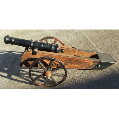 53 - A 19th century cast iron cannon mounted on a later wood and metal carriage. The barrel with GR cyphe... 