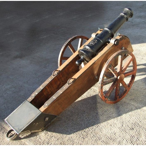 53 - A 19th century cast iron cannon mounted on a later wood and metal carriage. The barrel with GR cyphe... 