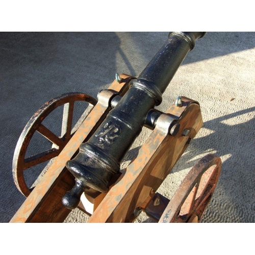 53 - A 19th century cast iron cannon mounted on a later wood and metal carriage. The barrel with GR cyphe... 