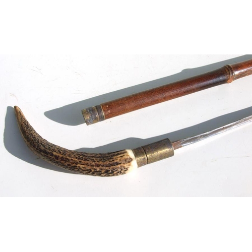 54 - A cane sword stick with 64.5cms (25.375ins) triangular steel blade and stag horn handle