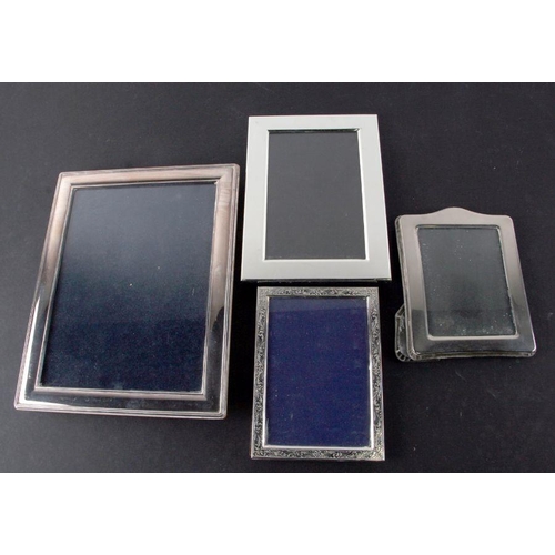 604 - A group of silver plated photo frames, the largest 18 by 23cms (4).