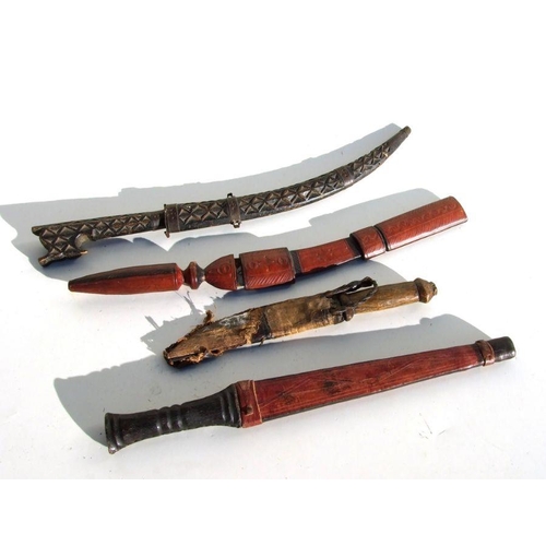 66 - Four North African daggers of varying sizes. The longest blade is 28cms (11ins)