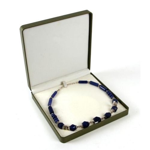 692 - An Egyptian style graduated sodalite bead and silver necklace, cased.