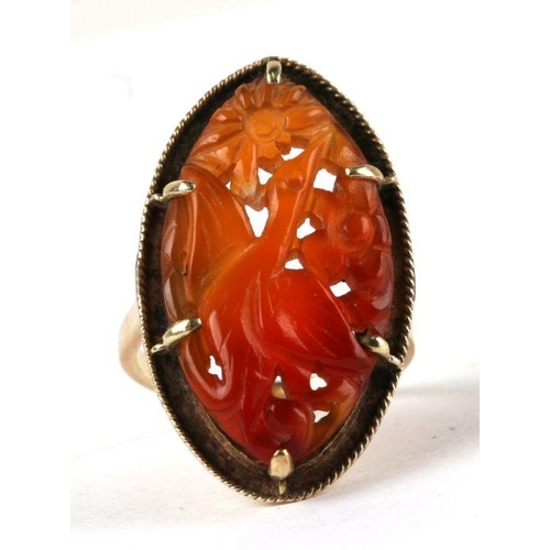 699 - A 14ct gold ring set with a pierced agate panel, probably Chinese, approx UK size 'K', 6.6g.