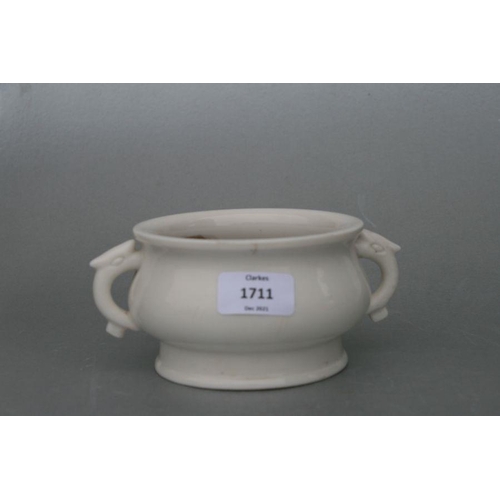 731 - A Chinese pottery two-handled censer with impressed seal mark to the underside, 13cms diameter.