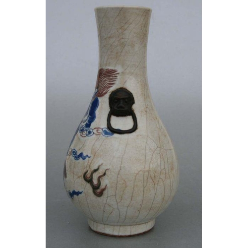 732 - A Chinese crackleware two-handled baluster vase decorated with shi shi, 26cms high.Condition Reportg... 