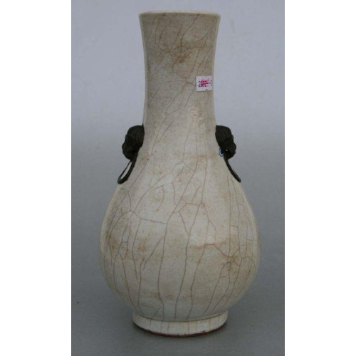 732 - A Chinese crackleware two-handled baluster vase decorated with shi shi, 26cms high.Condition Reportg... 