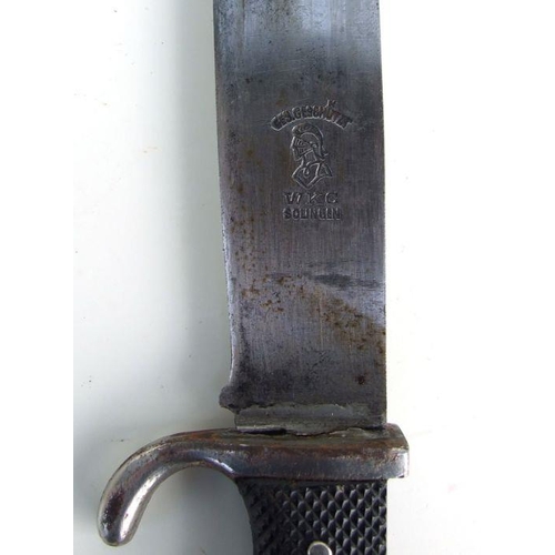 77 - A WWII Hitler Youth dagger, the blade stamped 'WKC Solingen Blut und Ehre', in a metal scabbard, 26c... 