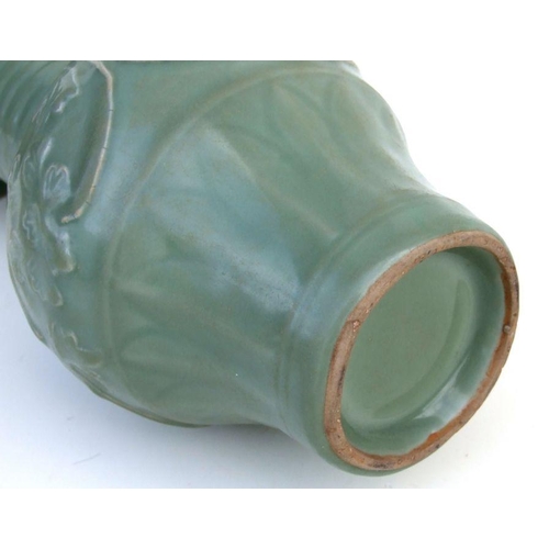 785 - A Chinese celadon vase decorated with scrolling foliage, 25cms high.