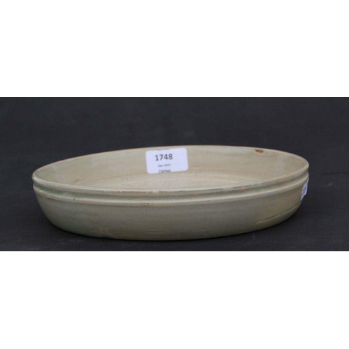 787 - A Chinese celadon glaze shallow dish or brush washer decorated with figures in a procession, 22cms d... 