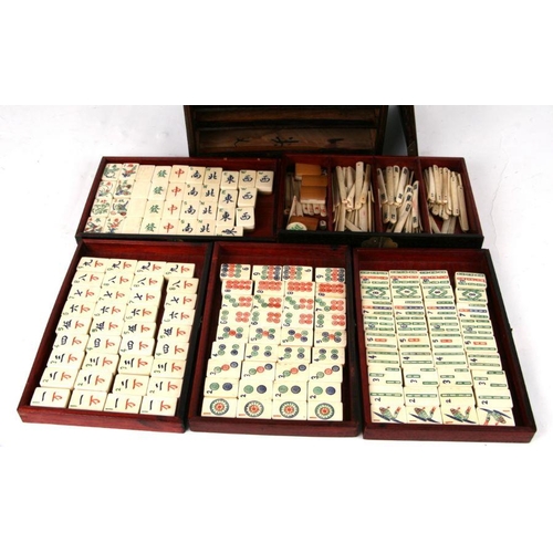 798 - A Chinese bone and bamboo Mah Jong set in a mother of pearl inlaid hardwood case, 24cms wide.