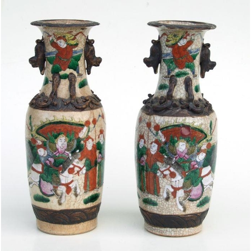 799 - A pair of Chinese famille rose crackle glaze vases decorated with warriors and applied chilong, inci... 