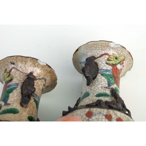 799 - A pair of Chinese famille rose crackle glaze vases decorated with warriors and applied chilong, inci... 