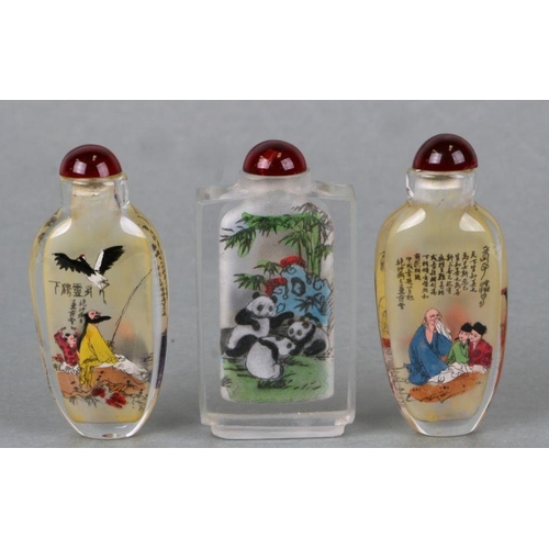 822 - Three Chinese reverse painted glass snuff bottles, the largest 8cm high (3).