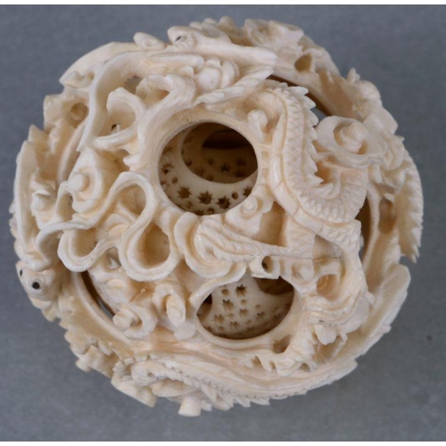 827 - An early 20th century Chinese ivory puzzle ball on stand 17cm high together with two Chinese ivory n... 