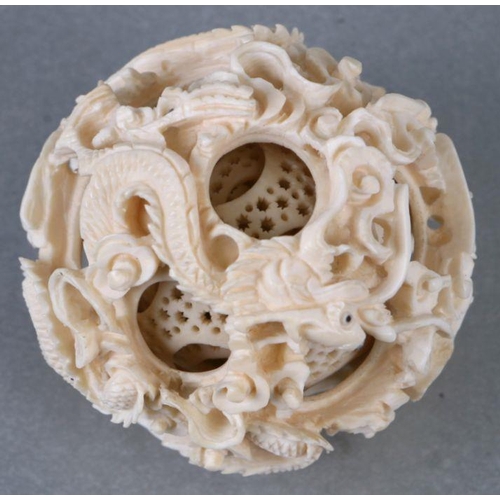 827 - An early 20th century Chinese ivory puzzle ball on stand 17cm high together with two Chinese ivory n... 