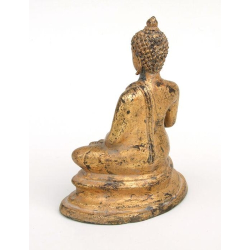 832 - An Asian gilded bronze figure in the form of a Buddha seated in meditation, 21cms high.