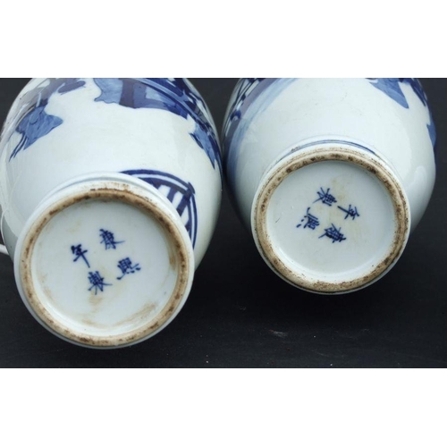 836 - A pair of Chinese blue & white baluster vases decorated with figures in a garden, blue four characte... 