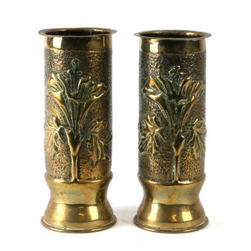 84 - A pair of WWI trench art brass artillery shells modelled in the form of vases with hammered relief d... 