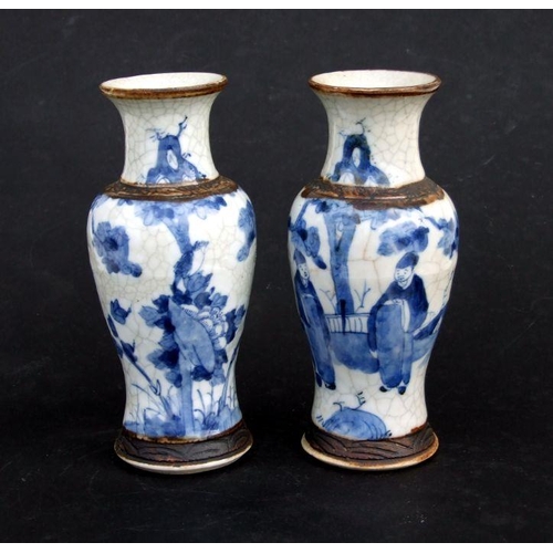 843 - A pair of Chinese blue & white crackle ware vases decorated with flowers, incised mark to the unders... 