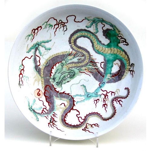 846 - A Chinese famille vert charger decorated with a scrolling dragon, 42cms diameter; together with a Ch... 