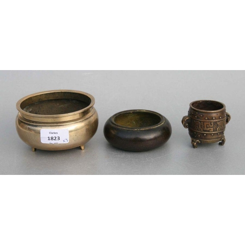 848 - A Chinese polished bronze / brass tripod censer, 12cms diameter; together with a Chinese bronze cens... 