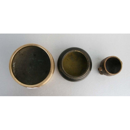 848 - A Chinese polished bronze / brass tripod censer, 12cms diameter; together with a Chinese bronze cens... 