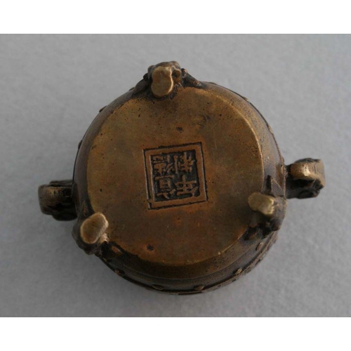 848 - A Chinese polished bronze / brass tripod censer, 12cms diameter; together with a Chinese bronze cens... 