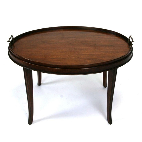 861 - A mahogany oval butlers tray table on tapering legs. 76cm wide