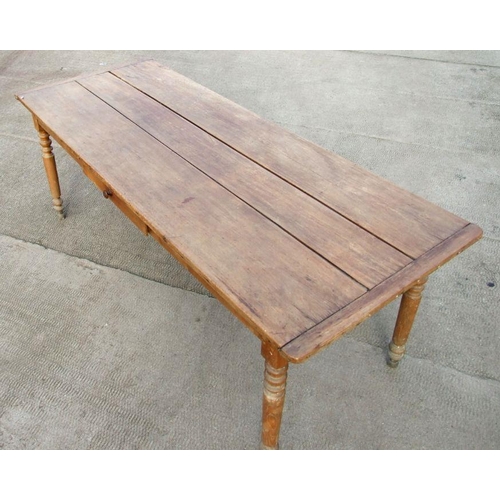 898 - A continental fruitwood farmhouse table with three plank top, single frieze drawer and turned legs, ... 