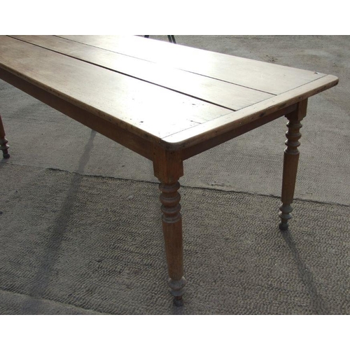 898 - A continental fruitwood farmhouse table with three plank top, single frieze drawer and turned legs, ... 