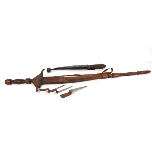 91 - A North African sword in tooled leather scabbard with multiple hidden blades, 10cms long; together w... 