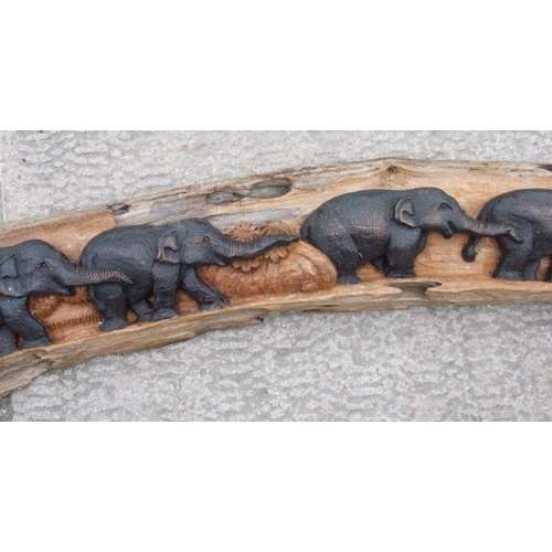 953 - A large Thai hardwood wall hanging carving depicting a herd of elephants, approx. 210cms long; toget... 