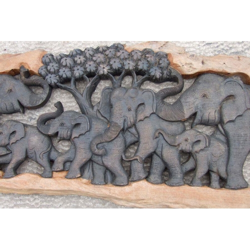 953 - A large Thai hardwood wall hanging carving depicting a herd of elephants, approx. 210cms long; toget... 