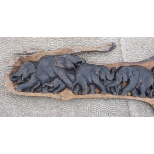 953 - A large Thai hardwood wall hanging carving depicting a herd of elephants, approx. 210cms long; toget... 