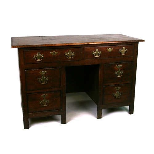 856 - An oak kneehole desk with an arrangement of six drawers, 126cms wide (adapted from an 18th century o... 