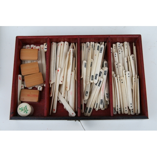 798 - A Chinese bone and bamboo Mah Jong set in a mother of pearl inlaid hardwood case, 24cms wide.