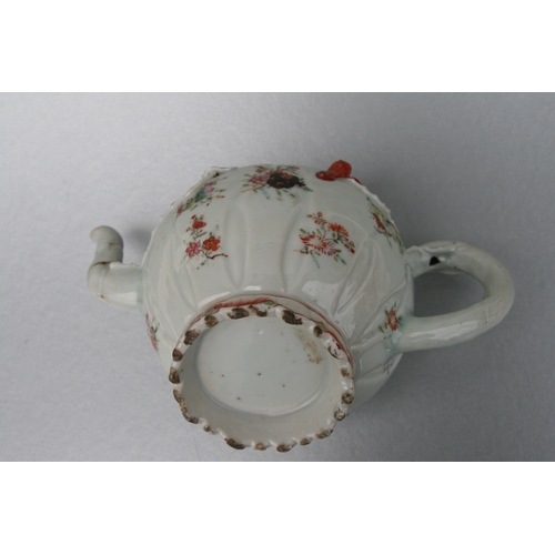 761 - A Chinese famille teapot decorated with flowers and applied scrolling flowers and foliage, 12cms hig... 